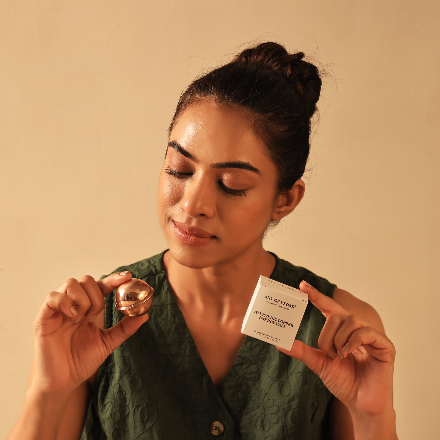 Art of Vedas Ayurveda Copper Energy Ball - Woman Holding Copper Energy Ball for Stress Relief and Energy Balance
